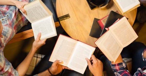 People gathered with books in hands; book reading