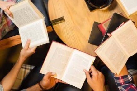 People gathered with books in hands; book reading