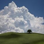 Landscape: a sunny cloud over a hill